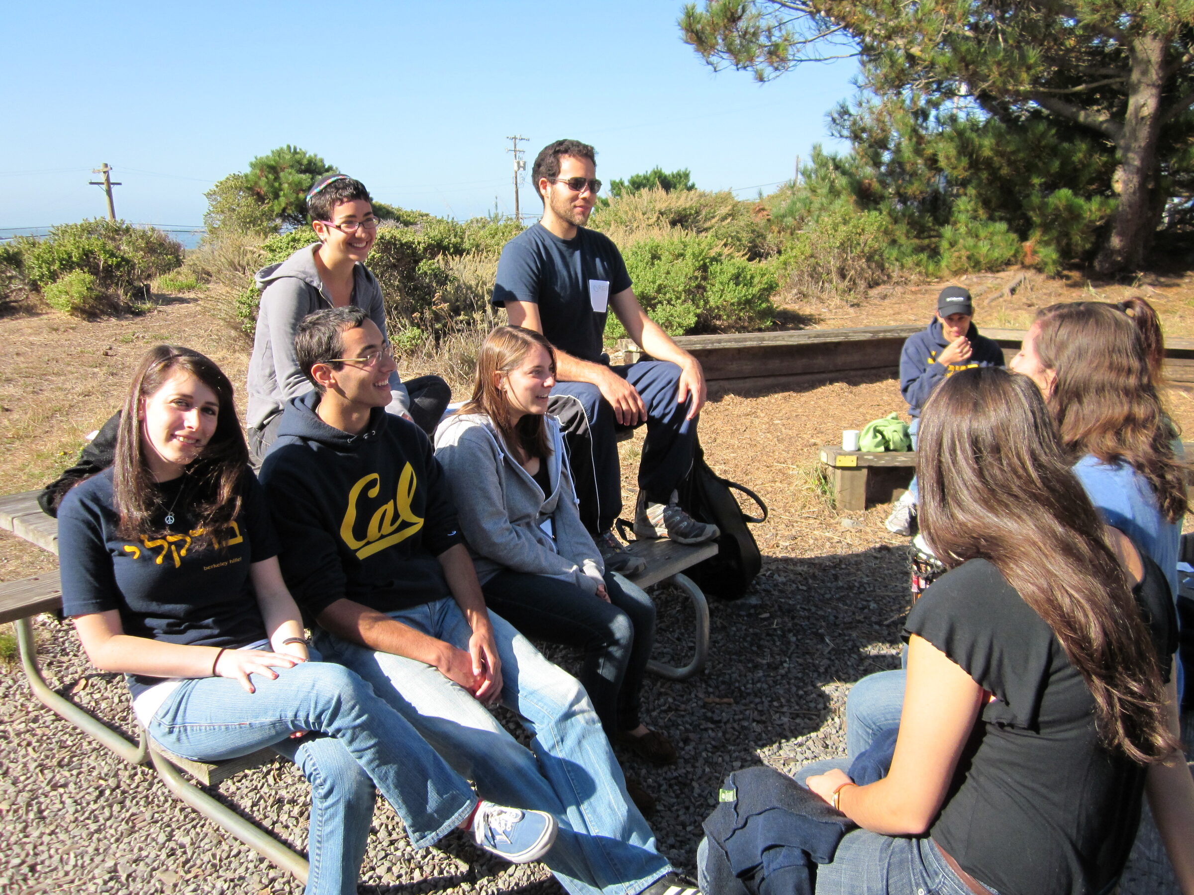 Students sitting together on a hillside in conversation
